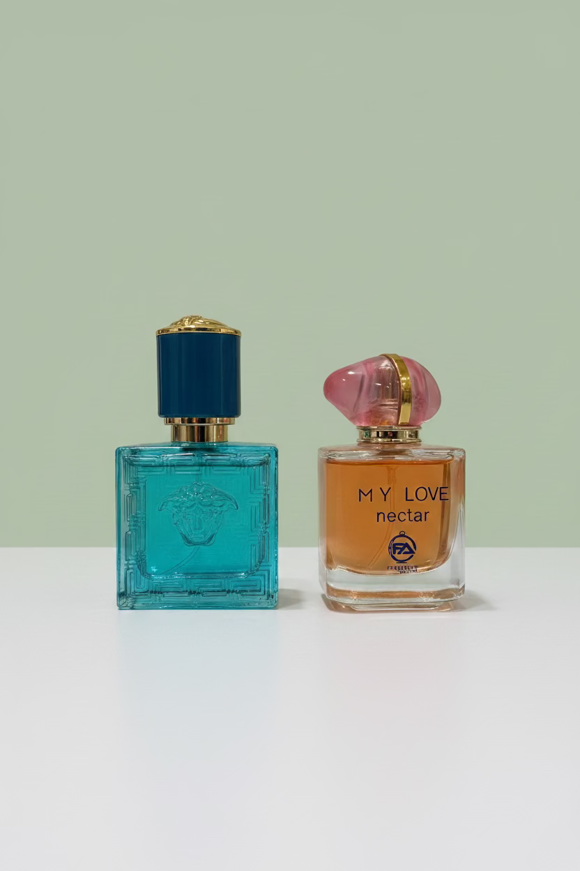Two perfume bottles, one blue and one orange, on a light surface with a blurred background.